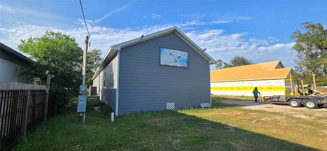 view of side of home featuring a lawn