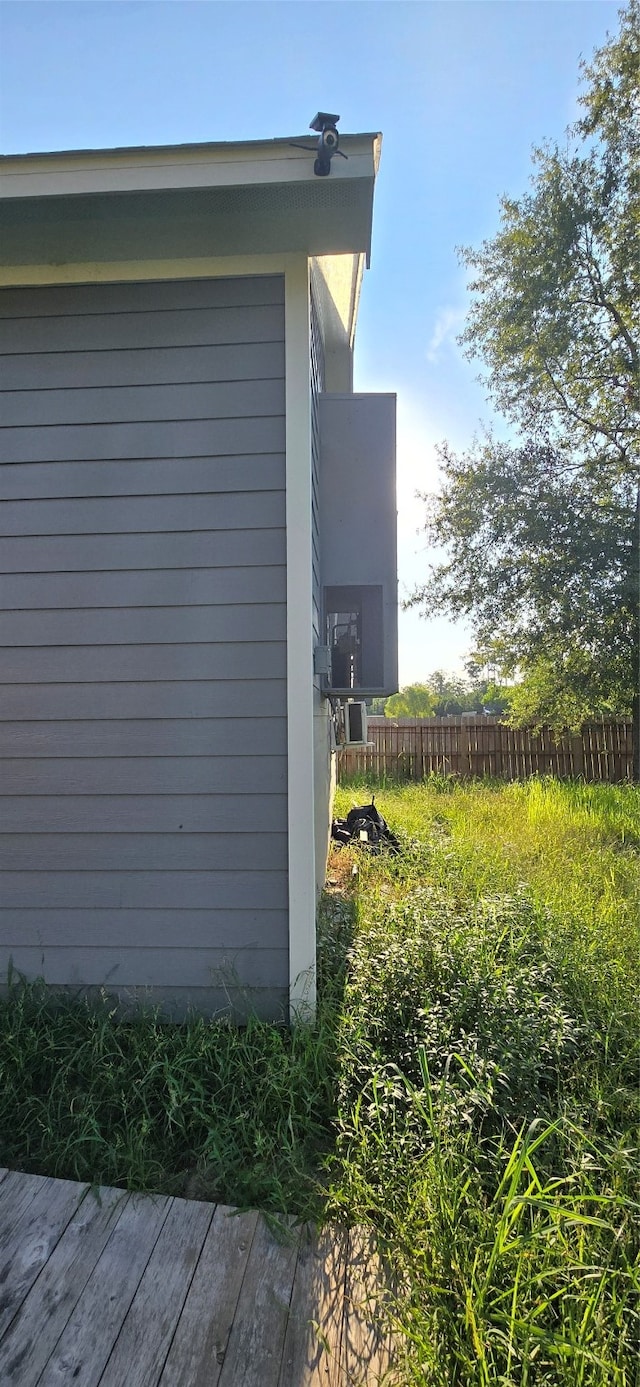 view of property exterior with a wooden deck