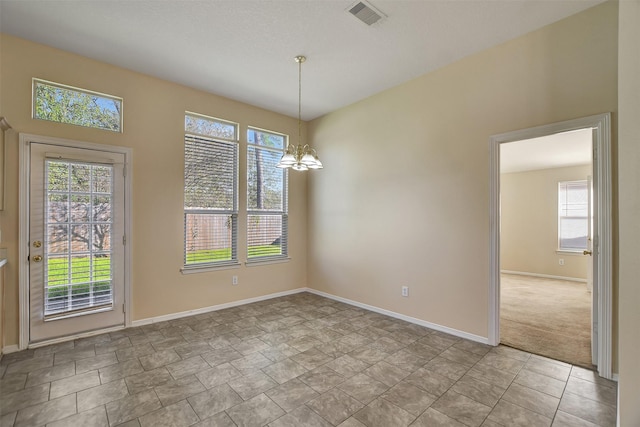 unfurnished dining area featuring an inviting chandelier and a healthy amount of sunlight