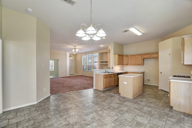 kitchen with ceiling fan with notable chandelier, sink, hanging light fixtures, light brown cabinetry, and kitchen peninsula