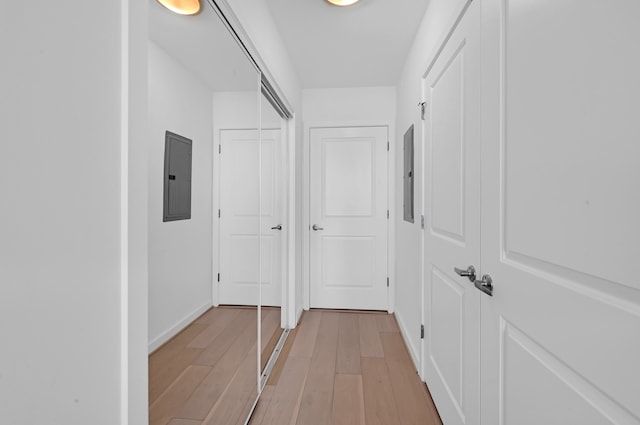 hallway with hardwood / wood-style flooring and electric panel