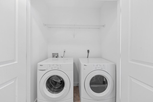 washroom with tile patterned flooring and washing machine and dryer