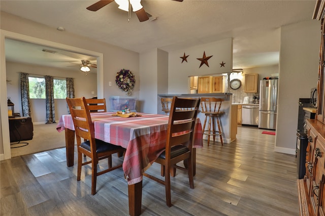 dining room featuring ceiling fan and hardwood / wood-style floors