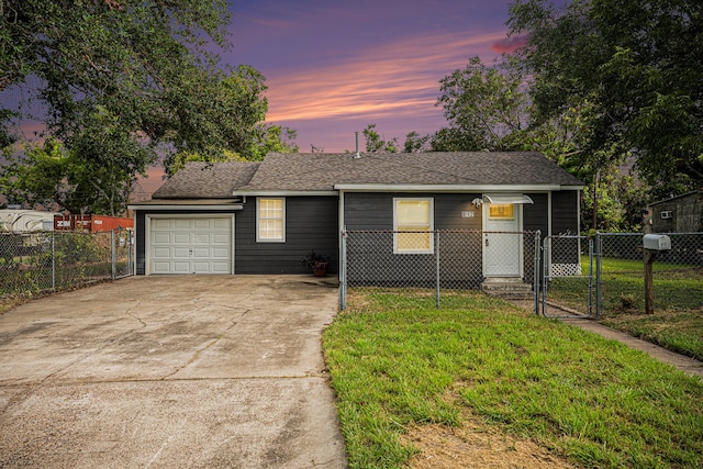 view of front of house with a yard and a garage