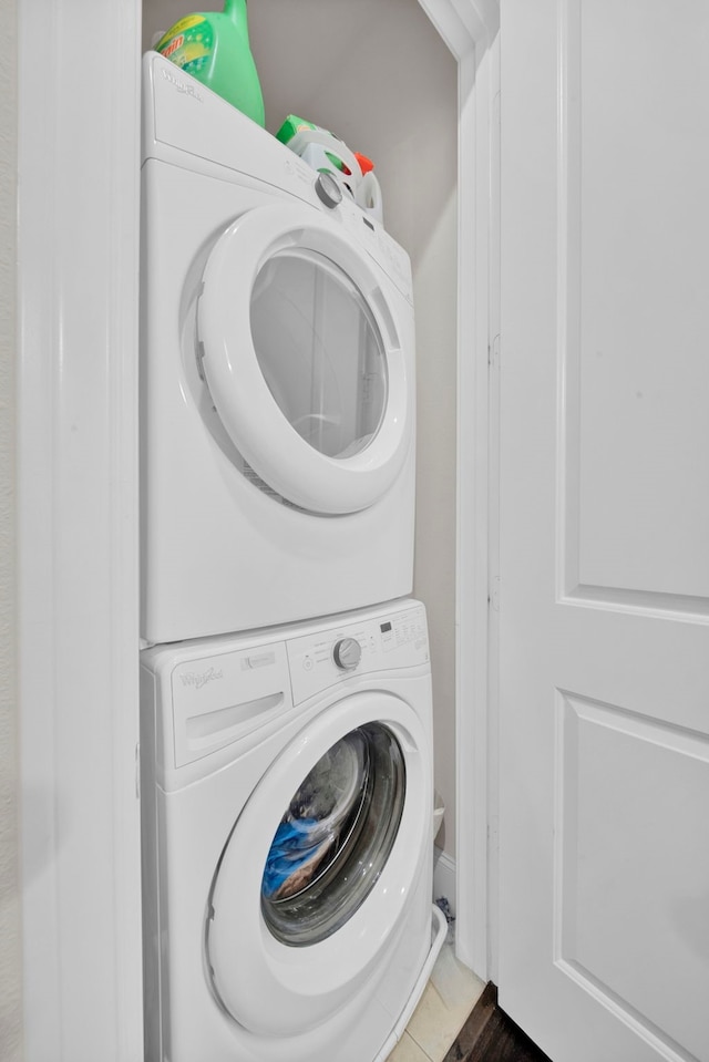 washroom with tile patterned floors and stacked washer / dryer