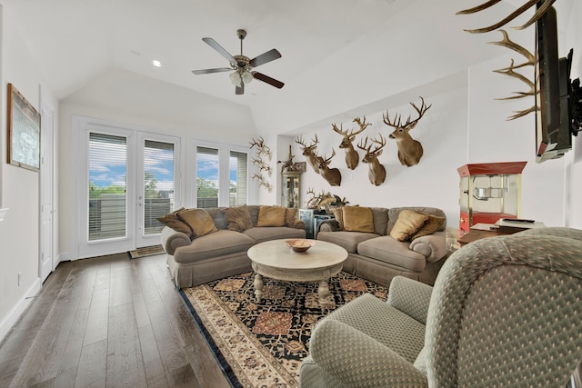 living room featuring dark hardwood / wood-style flooring, ceiling fan, and lofted ceiling