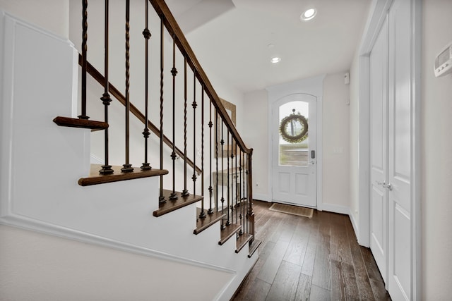 entryway with dark hardwood / wood-style flooring