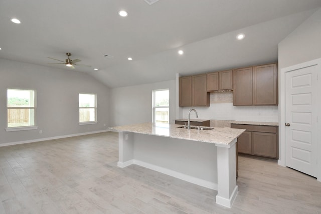 22022 Villa Terrace Dr, Hockley, TX 77447 - kitchen featuring sink, ceiling fan, light hardwood / wood-style floors, and backsplash