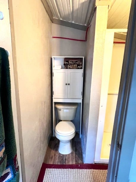 bathroom with toilet and hardwood / wood-style flooring