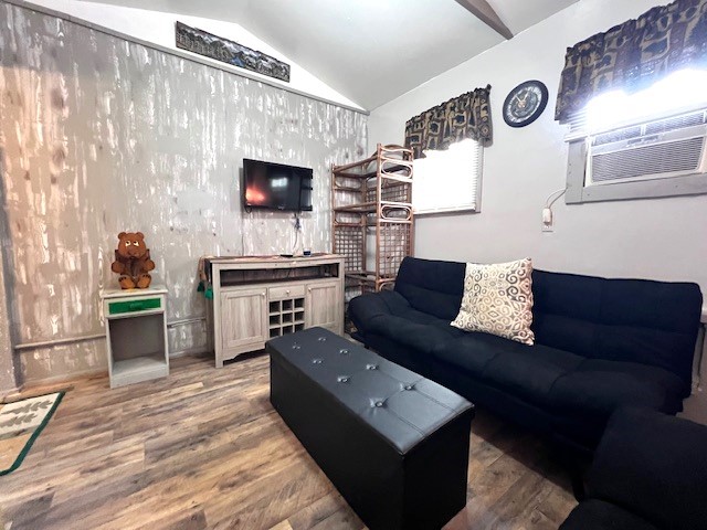 living room with lofted ceiling and hardwood / wood-style flooring