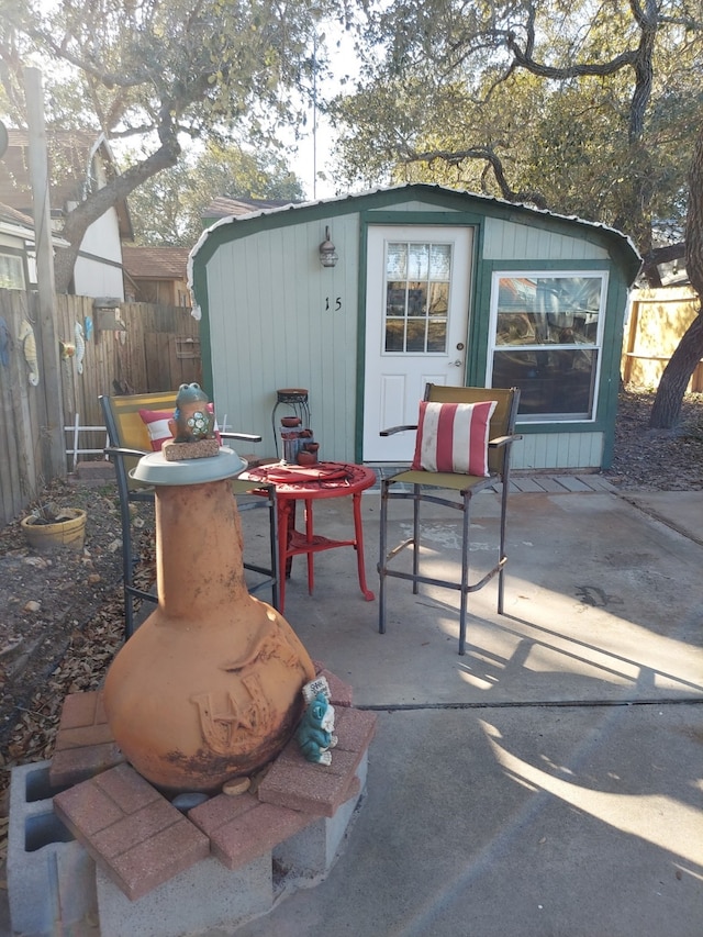 view of patio with an outbuilding