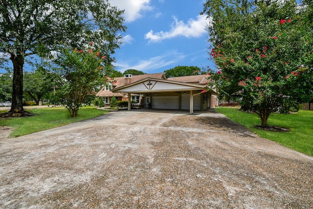 single story home featuring a front lawn and a carport