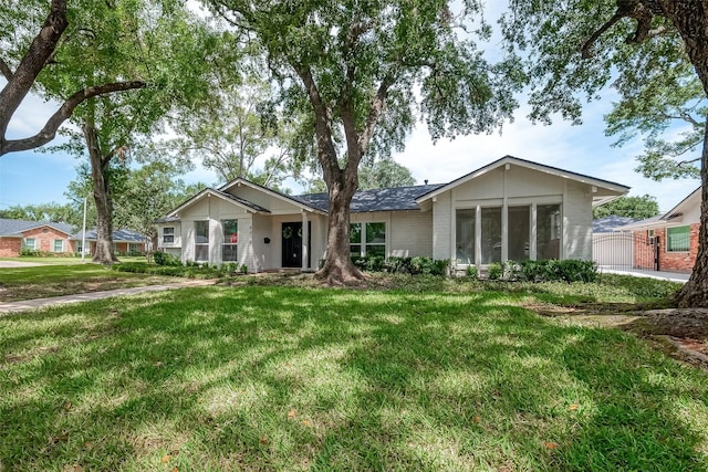 ranch-style home with a front lawn