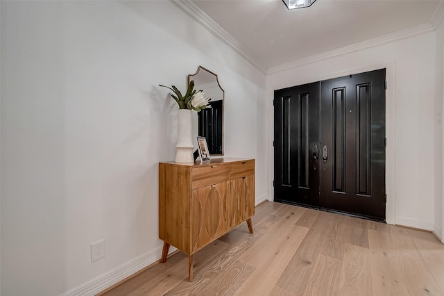 entryway with light hardwood / wood-style flooring and crown molding