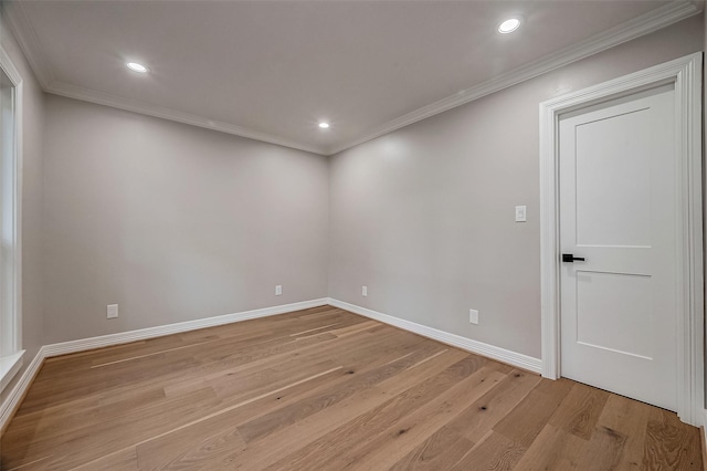 unfurnished room featuring light hardwood / wood-style flooring and crown molding