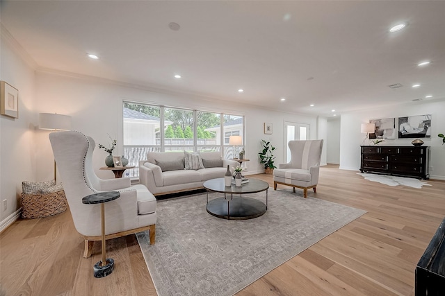 living room featuring light hardwood / wood-style floors and crown molding