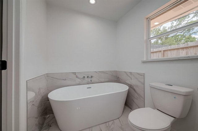 bathroom featuring a bathtub and toilet