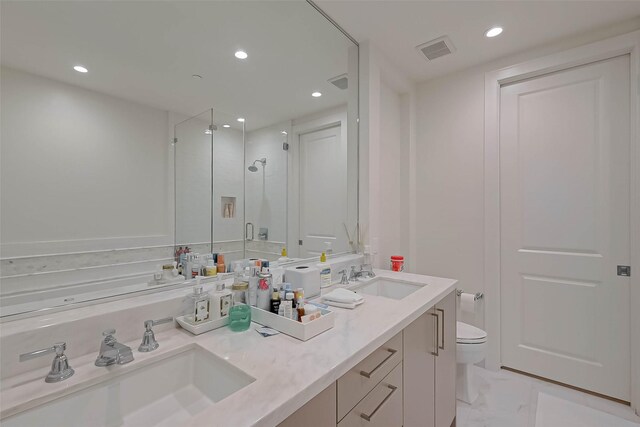 bathroom featuring tile patterned flooring, toilet, an enclosed shower, and vanity