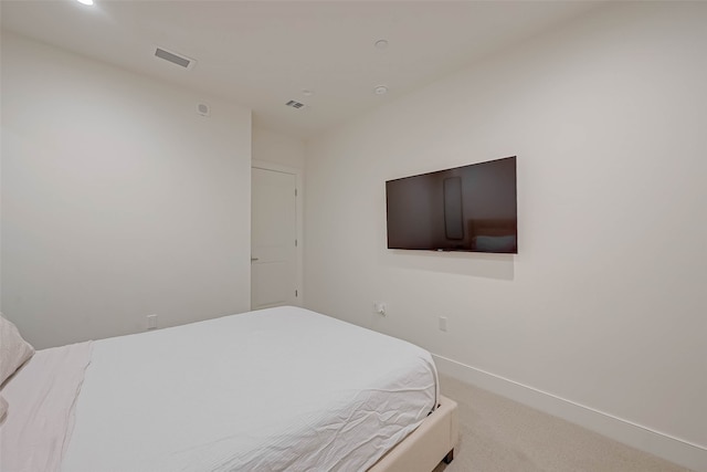 bedroom featuring light carpet