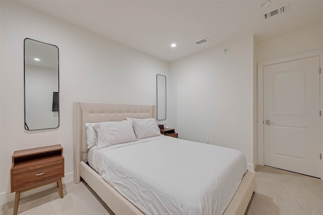 bedroom with light colored carpet