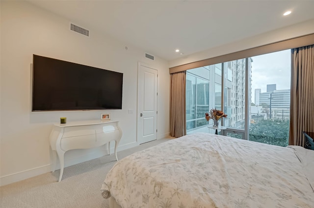 bedroom featuring access to exterior and light colored carpet