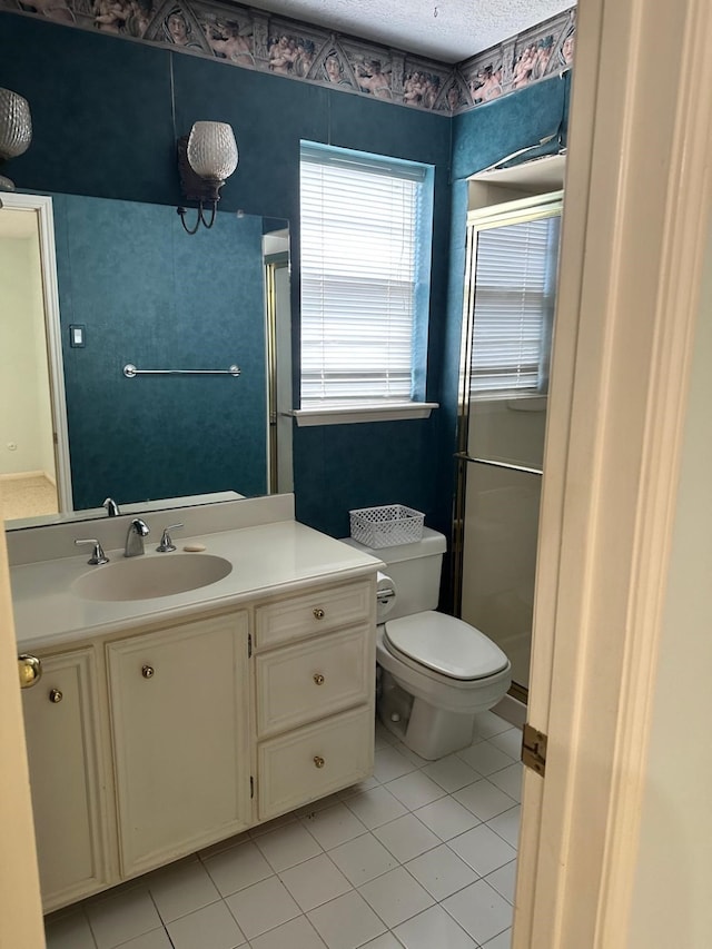 bathroom with tile patterned floors, toilet, an enclosed shower, and vanity