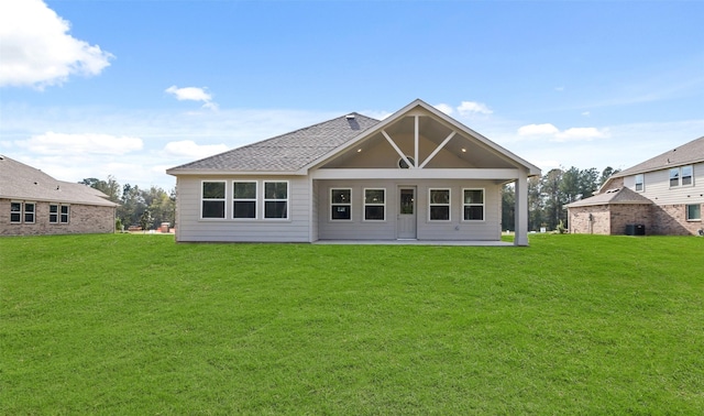 back of property featuring cooling unit, a patio, and a lawn