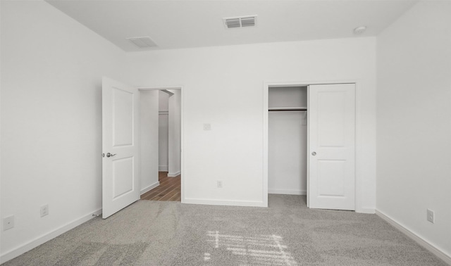 unfurnished bedroom with carpet floors and a closet