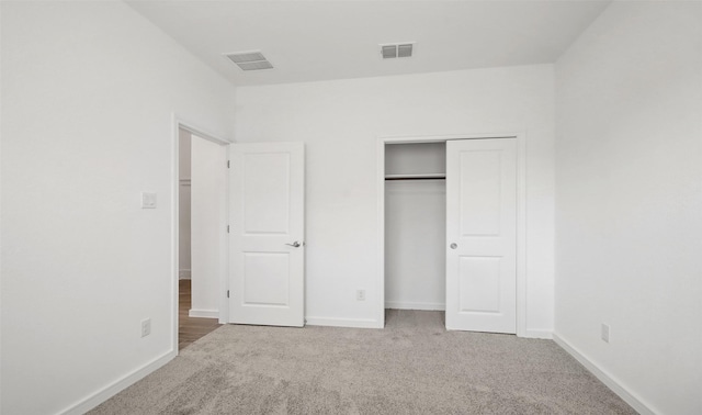 unfurnished bedroom with carpet floors and a closet