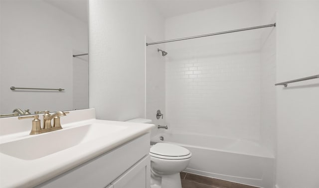 full bathroom featuring hardwood / wood-style flooring, tiled shower / bath, vanity, and toilet