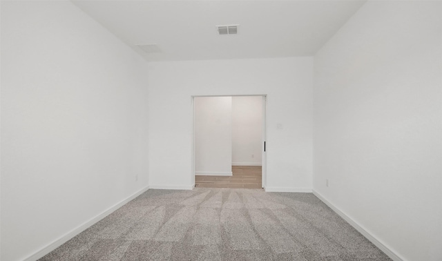 unfurnished room with light carpet