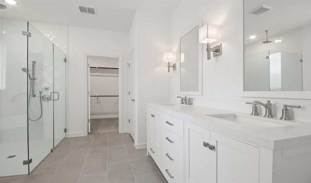 bathroom with vanity, tile patterned floors, and walk in shower