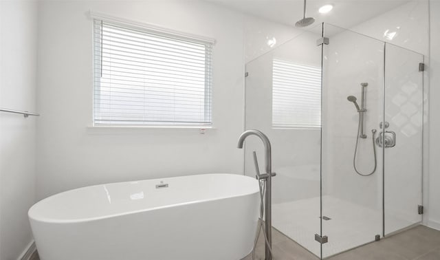 bathroom featuring independent shower and bath