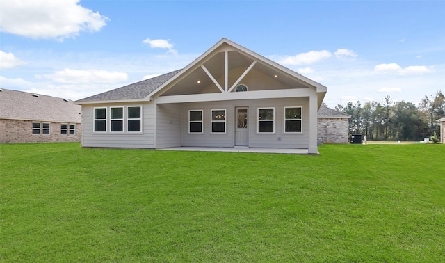 rear view of house with a yard and a patio area