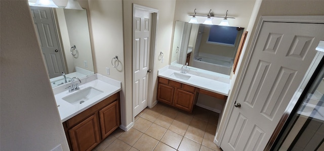 bathroom featuring vanity, a tub, and tile patterned flooring