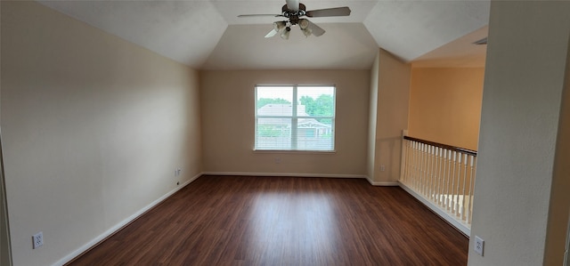 empty room with dark wood-type flooring, vaulted ceiling, and ceiling fan