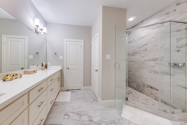 bathroom with double vanity, baseboards, marble finish floor, a shower stall, and a sink