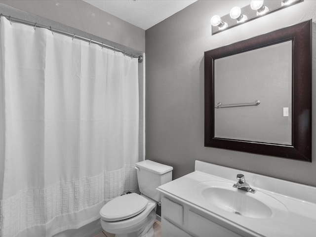 bathroom with a shower with curtain, vanity, a textured ceiling, and toilet