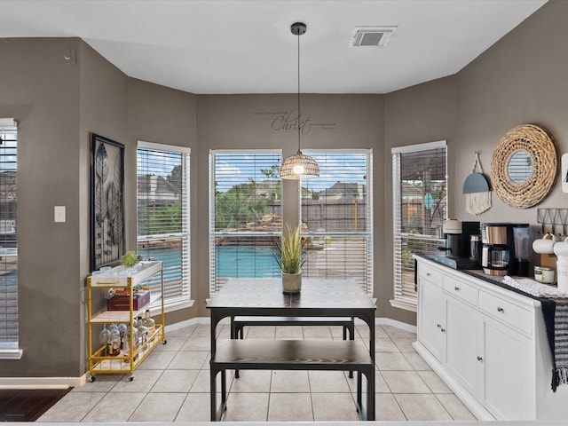 dining room featuring light tile patterned floors and plenty of natural light