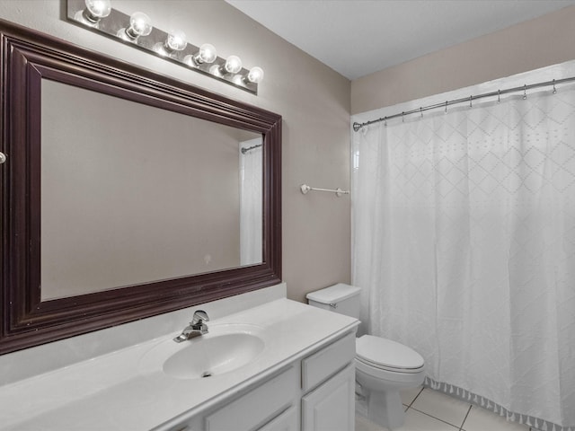 bathroom with vanity, tile patterned floors, and toilet