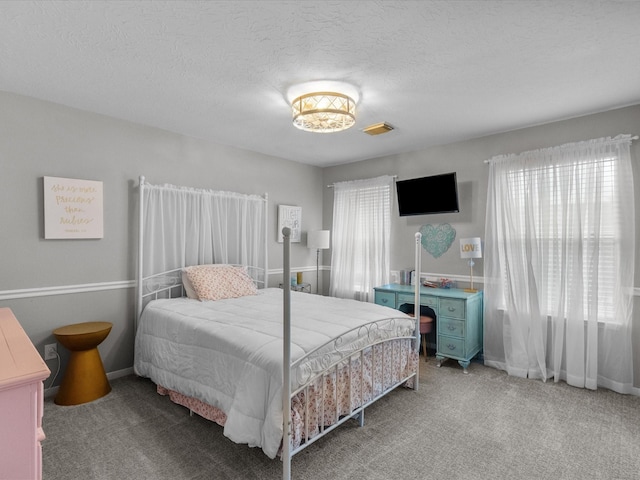 bedroom with carpet flooring and a textured ceiling