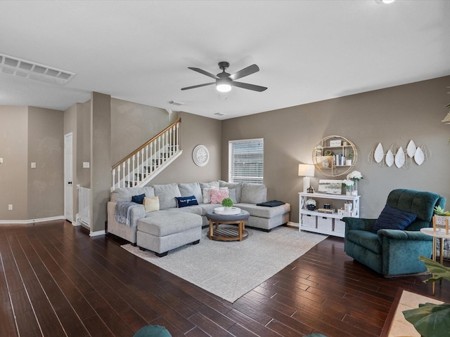 living room featuring ceiling fan and dark hardwood / wood-style flooring