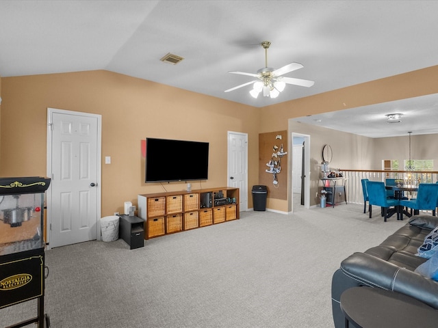 living room featuring vaulted ceiling, carpet, and ceiling fan