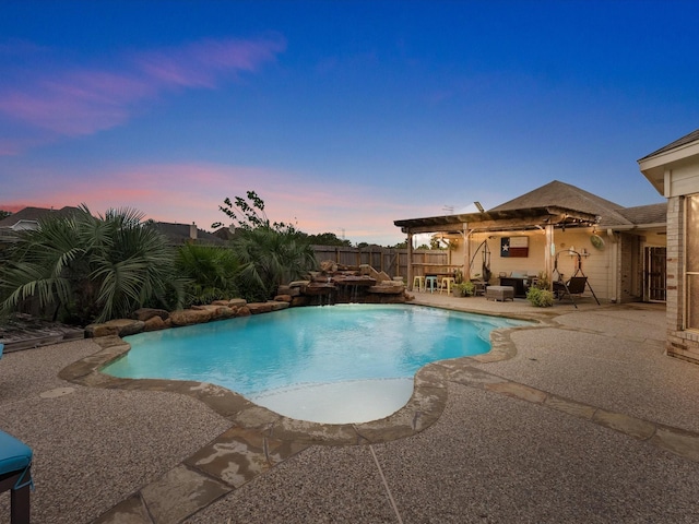 pool at dusk with a patio