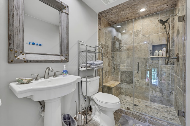 bathroom with tile patterned flooring, an enclosed shower, and toilet