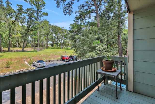 wooden terrace featuring a yard