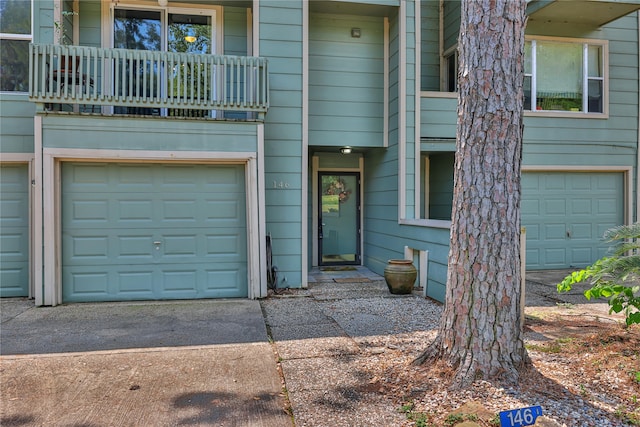 view of front of property featuring a garage and a balcony