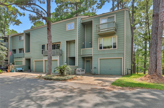 view of front of home featuring a balcony and a garage