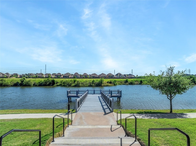 view of dock featuring a water view and a lawn