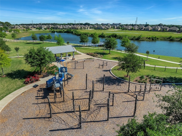 view of property's community featuring a playground, a water view, and a yard